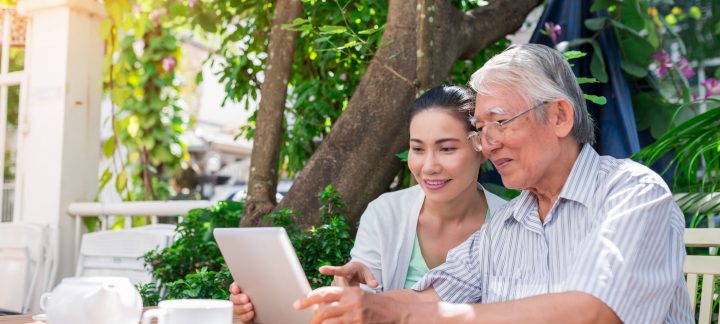 daughter and father on laptop